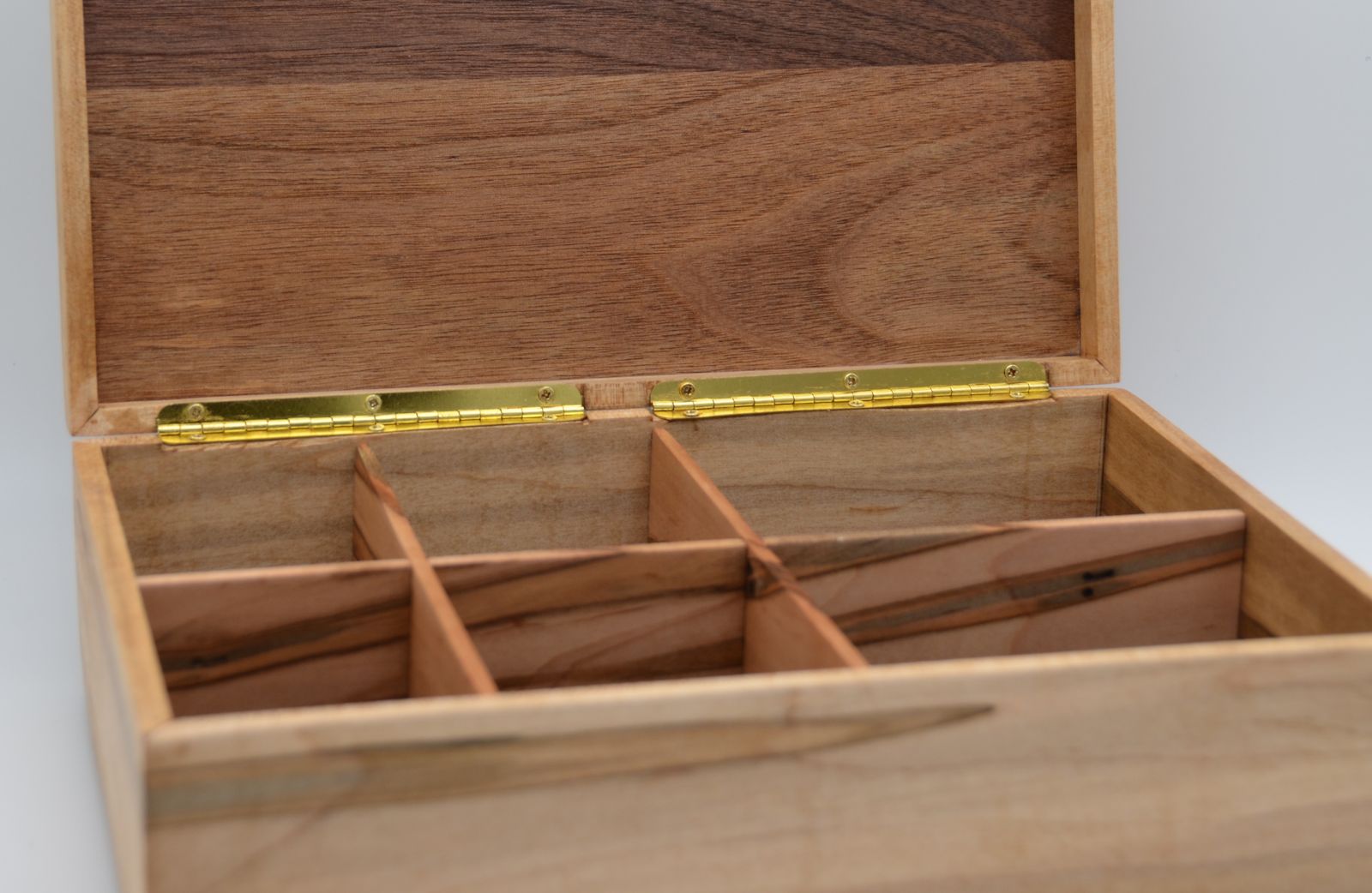 An open wooden box showing the interior.