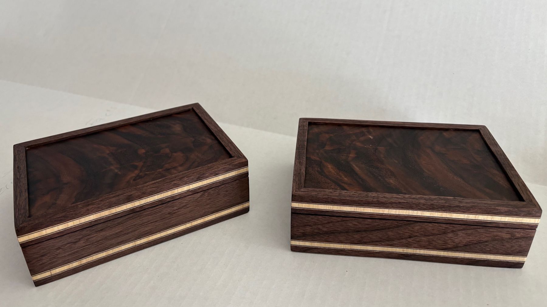 Two similar boxes side by side, showing variation in wood and detail.